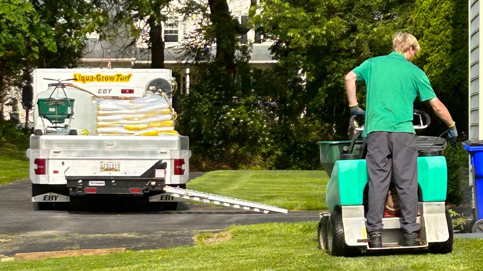 Lawn care and pest control employee working.