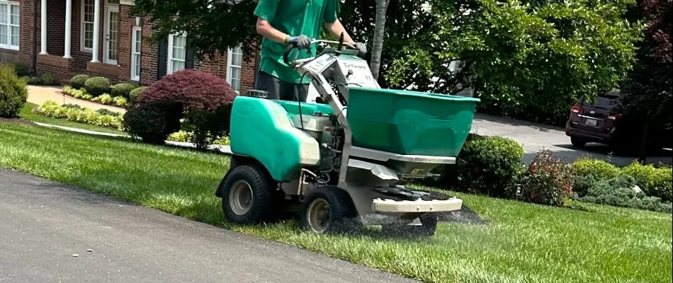 Worker fertilizing a lawn in Westminster, MD.