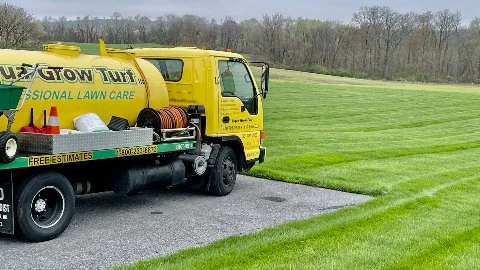 Company truck in front of a fertilized yard.