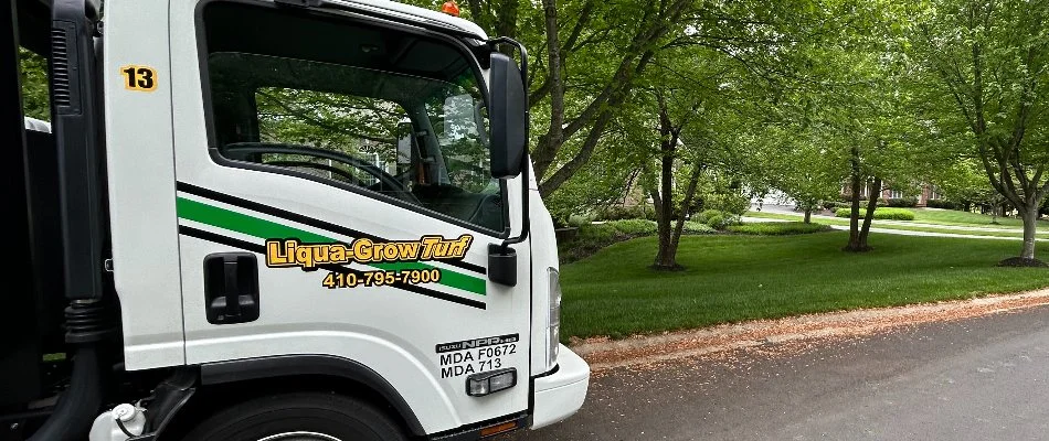 Company truck in Westminster, MD, with a lawn and trees in back.